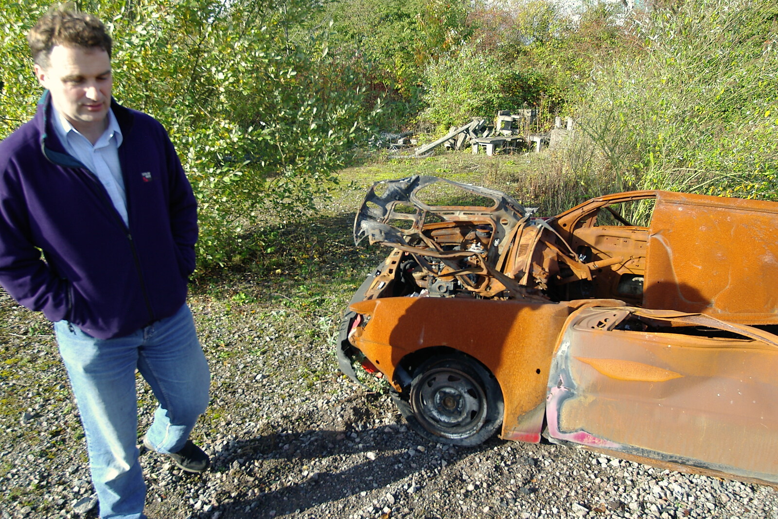Dan roams around amongst the wrecked cars from Disused Cambridge Railway, Milton Road, Cambridge - 28th October 2005