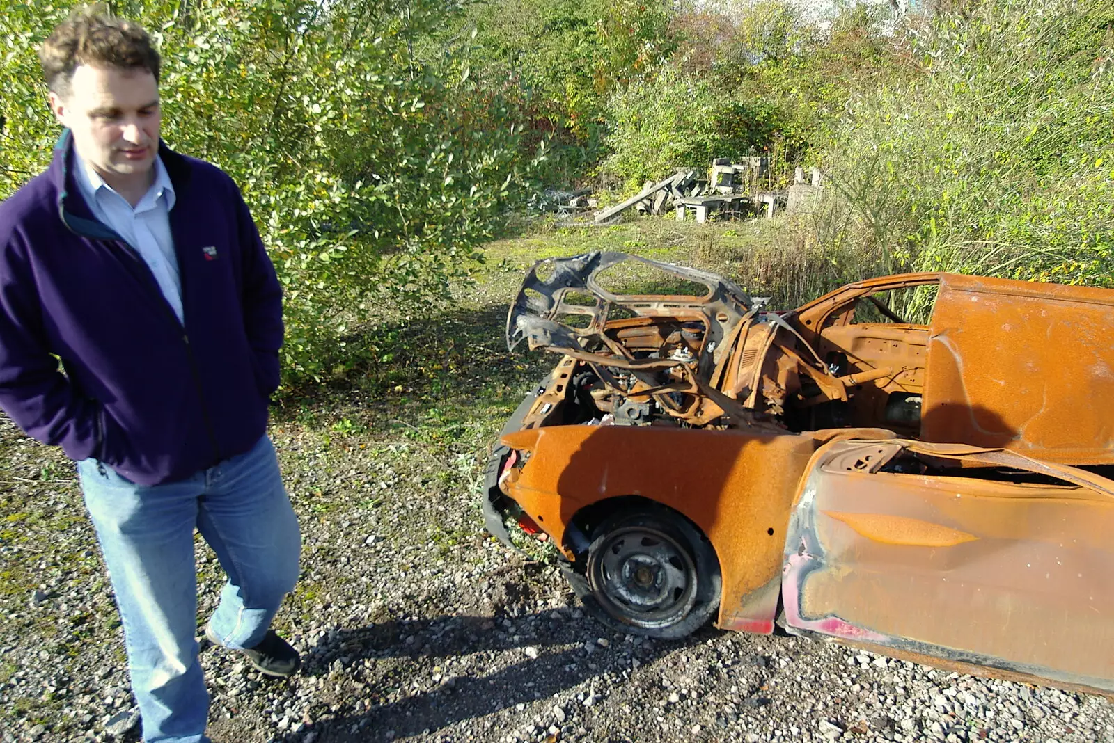 Dan roams around amongst the wrecked cars, from Disused Cambridge Railway, Milton Road, Cambridge - 28th October 2005