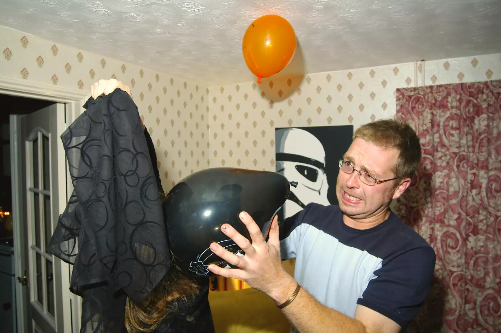 Marc gets to grips with a staticky balloon, from Jen's Hallowe'en Party and Sazzle's Leaving Do, Mission Road, Diss - 28th October 2005