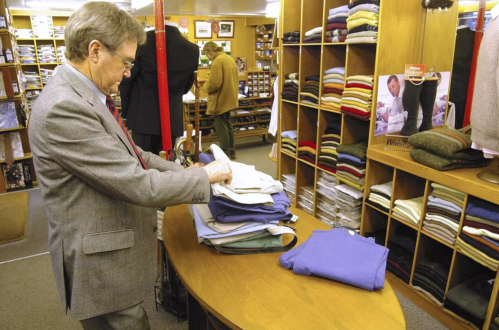 Peter checks a pile of clothing, from A Portrait of Hopgoods: Gentlemen's Outfitters, Diss, Norfolk - 4th January 2006