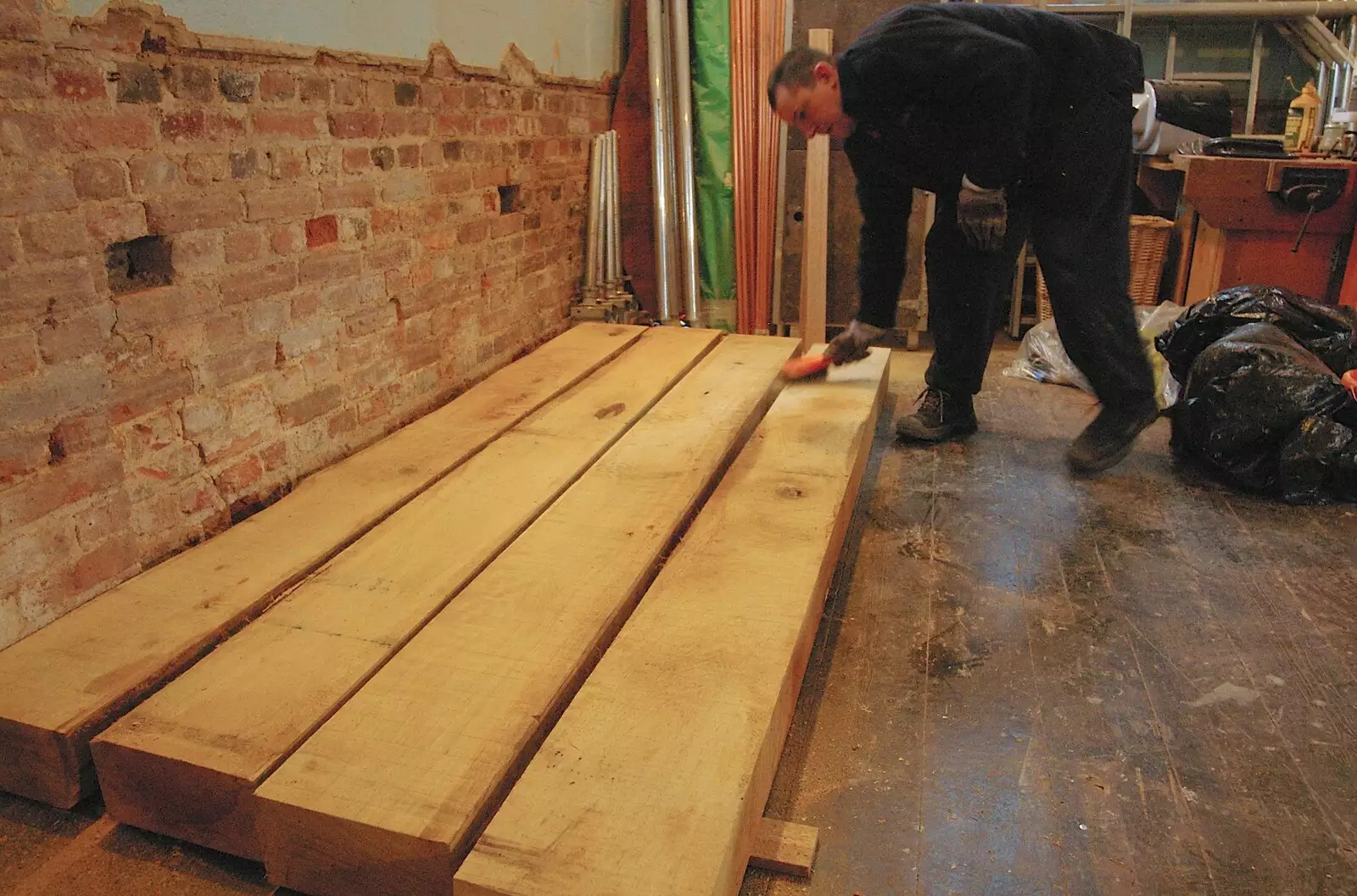 Dom sweeps off dust from some nice oak timbers, from Dom in da Chapel, Safeway Chickens and Evil Supermarkets, Harleston and Grimston - 15th January 2006