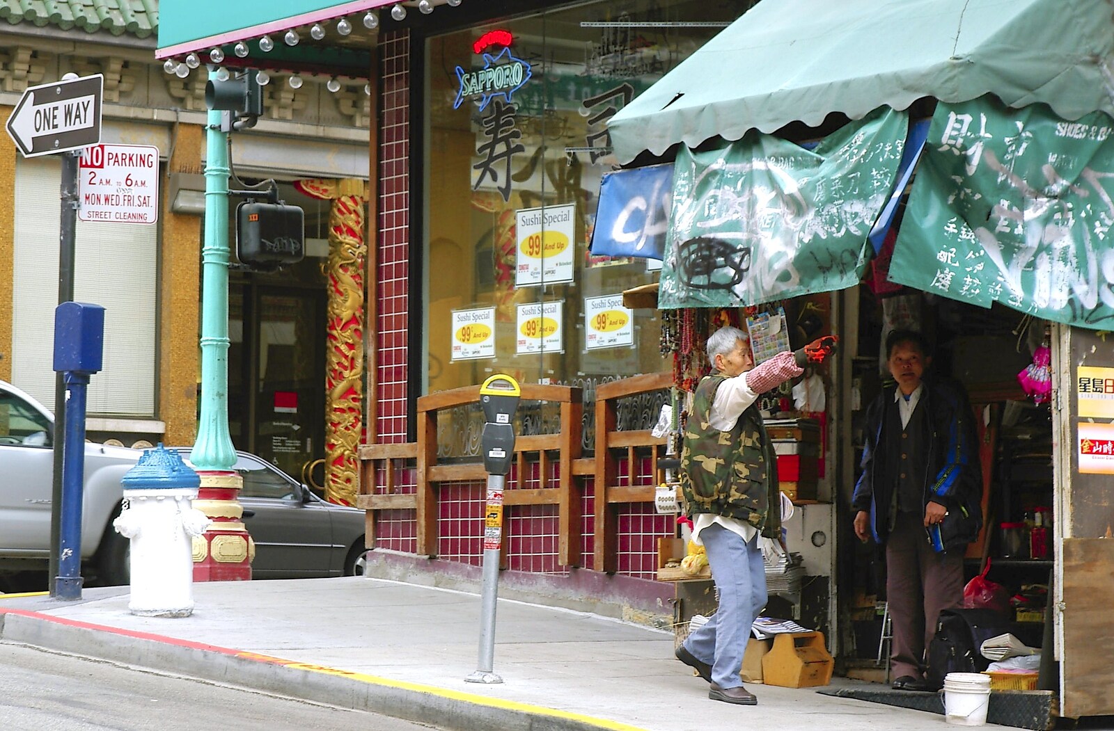 A shopkeeper opens up from Chinatown, Telegraph Hill and Fisherman's Wharf, San Francisco, California, US - 11th March 2006