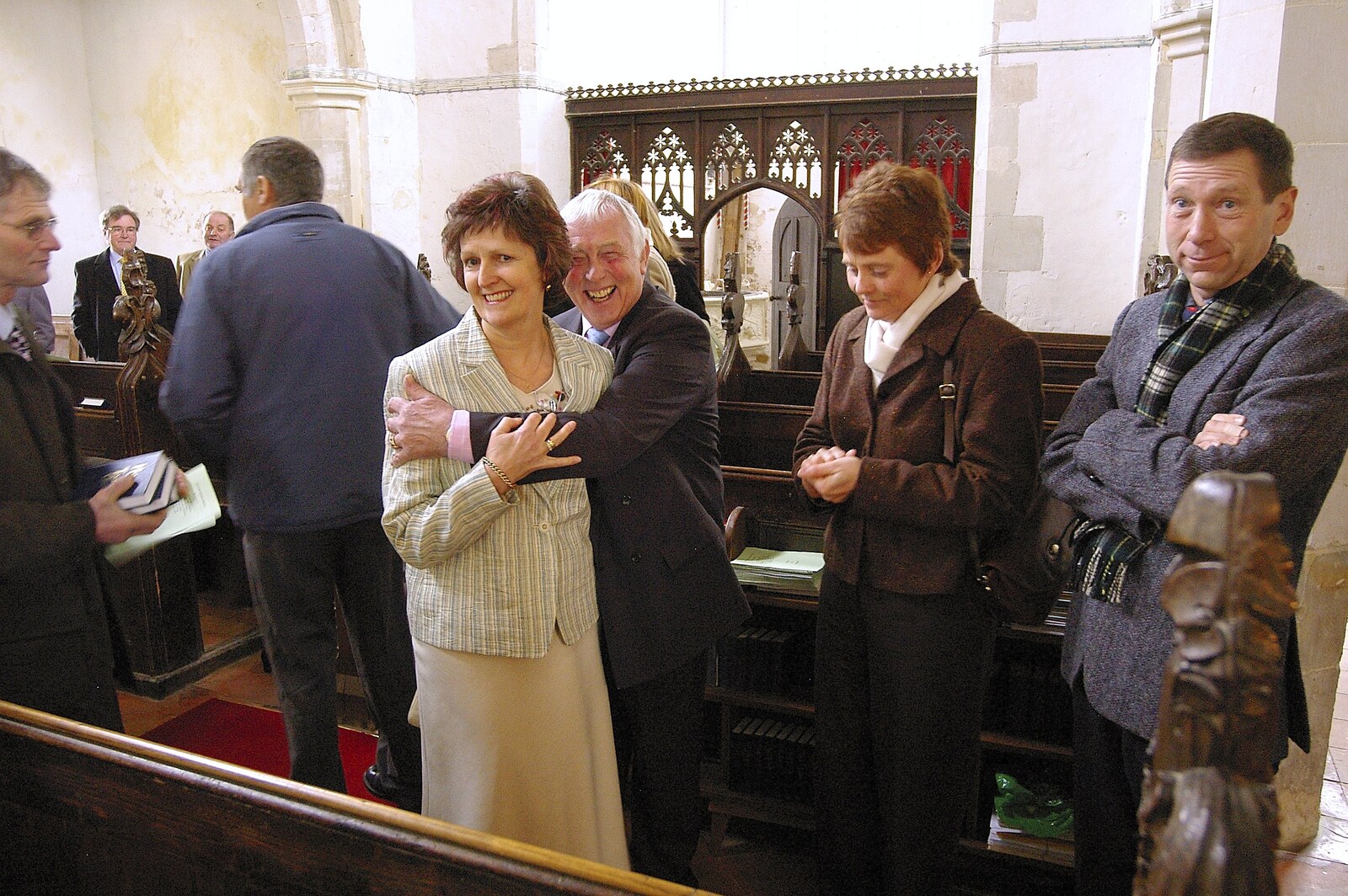 Colin gives Jill a hug as Apple looks surprised from Clairesprog Christening, Church of St. Margaret of Antioch, Thrandeston, Suffolk - 19th March 2006