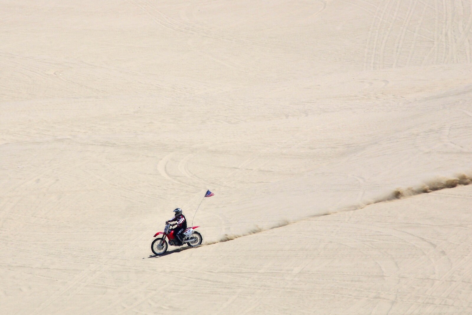 A guy on a bike razzes down a huge dune from San Diego Seven: The Desert and the Dunes, Arizona and California, US - 22nd April