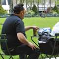 In Bryant Park, an off-duty Elvis impersonator takes a break and listens to 