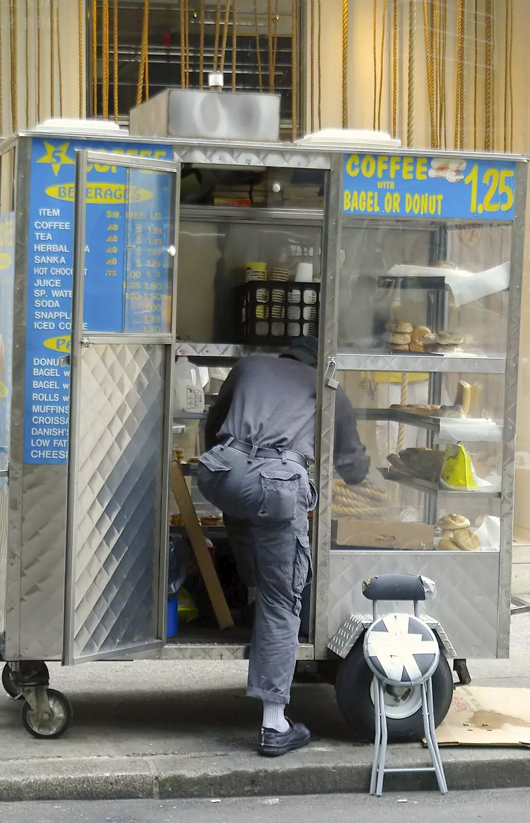 A guy escapes by climbing into his hot-dog van, from A Union Square Demo, Bryant Park and Columbus Circle, New York, US - 2nd May 2006