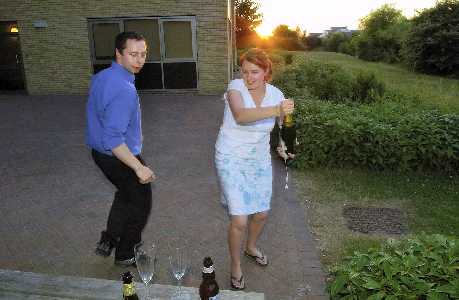 Isobel with some overflowing champagne, from Qualcomm's New Office Party, Science Park, Milton Road, Cambridge - 3rd July 2006