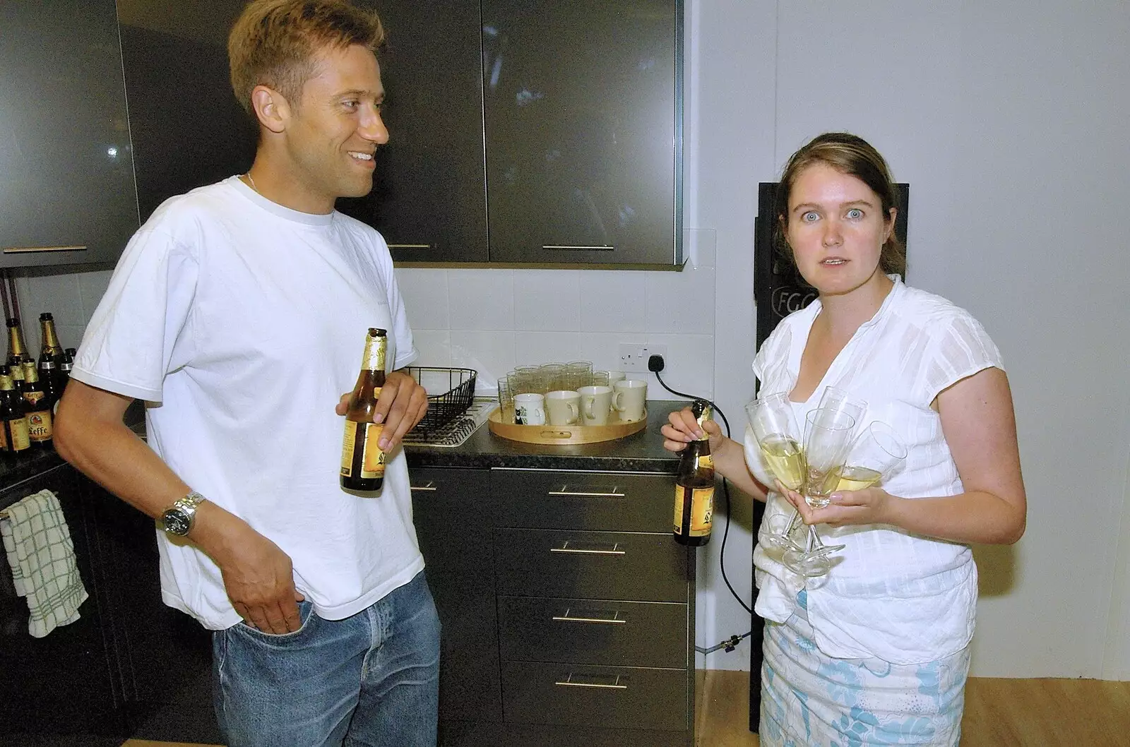 Andrew and a suprised-looking Isobel help tidy up, from Qualcomm's New Office Party, Science Park, Milton Road, Cambridge - 3rd July 2006