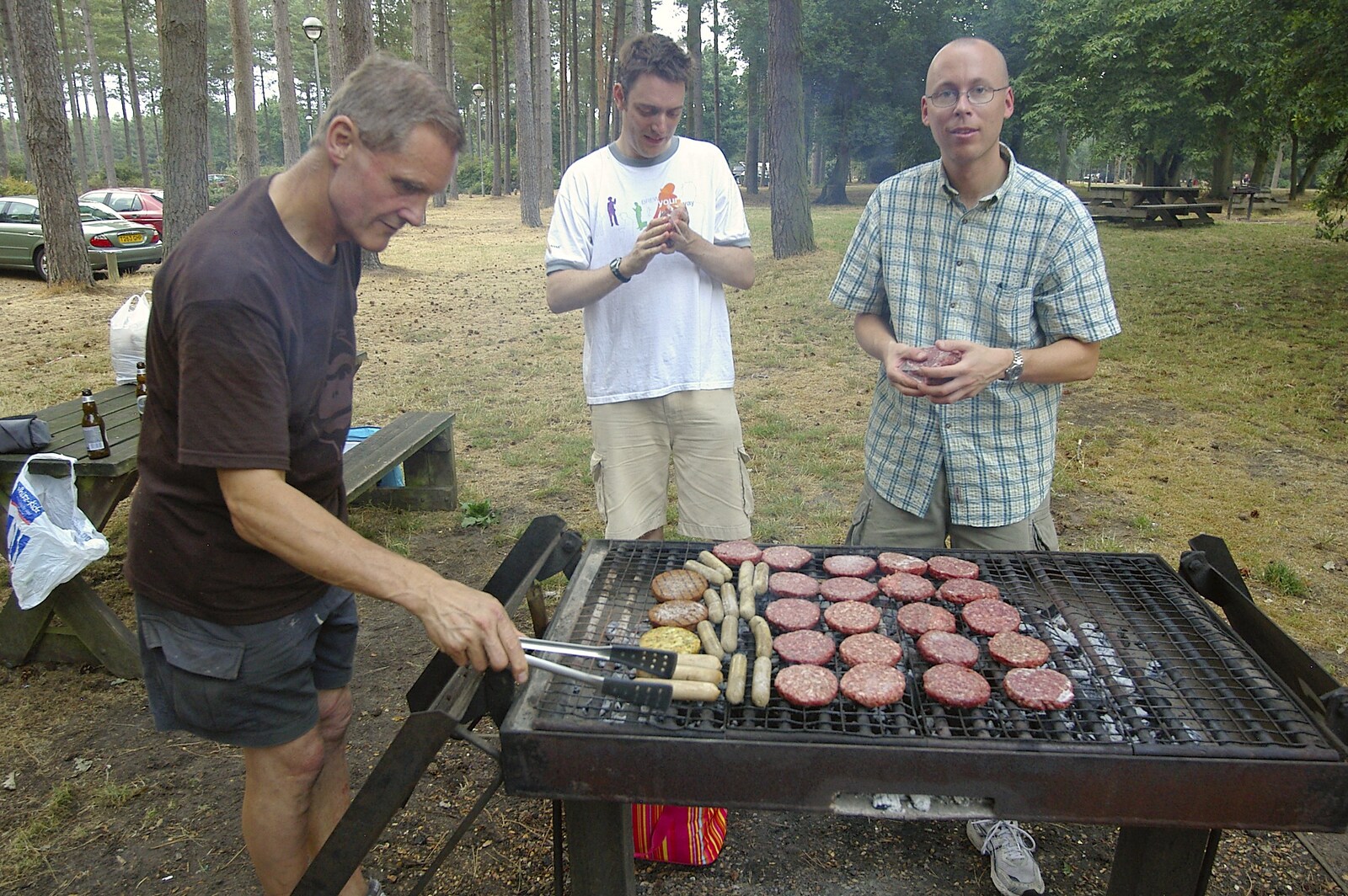Tim Simpson pokes a sausage from Qualcomm Cambridge "Go Ape", High Lodge, Thetford Forest - 27th July 2006