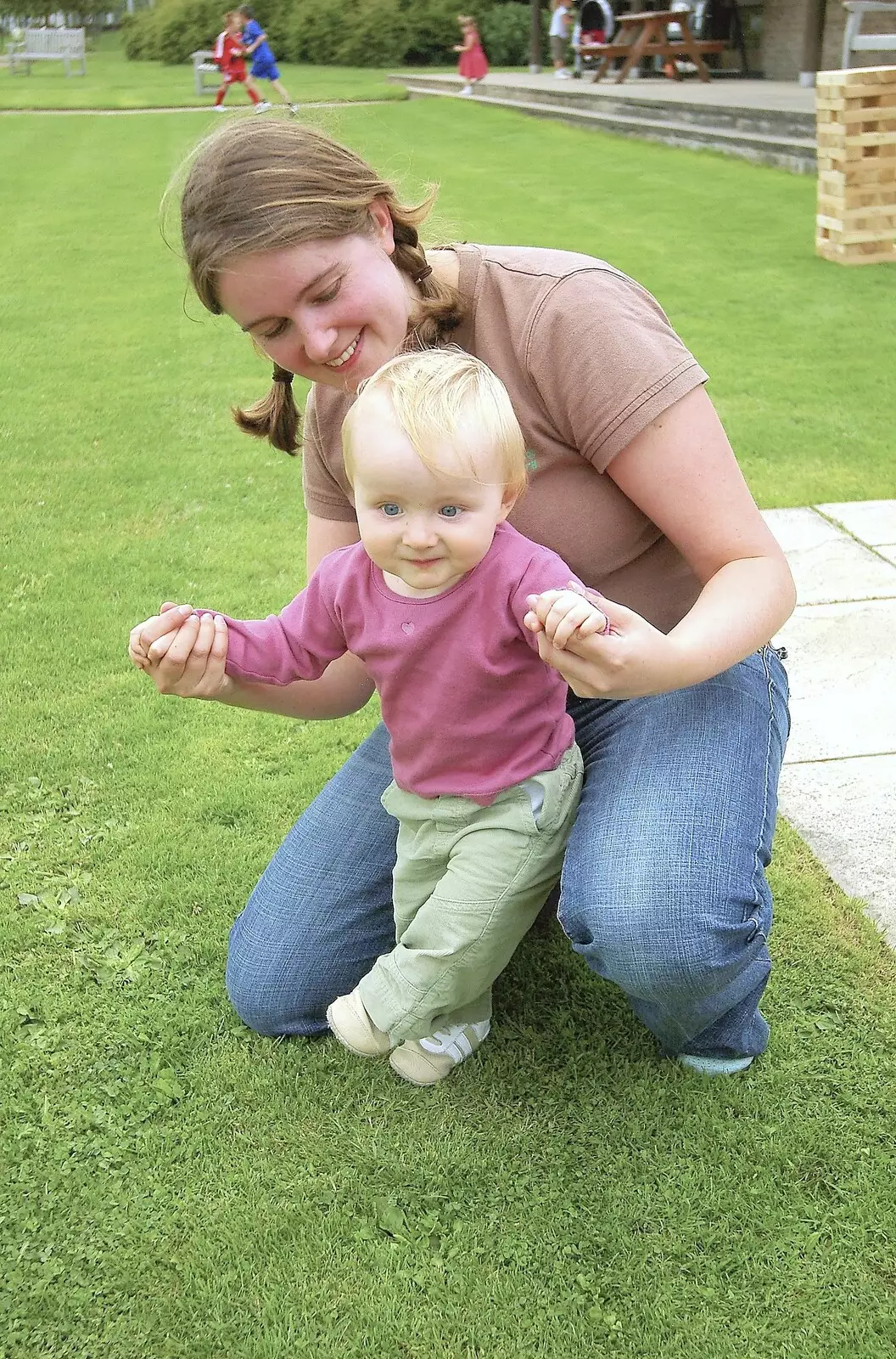 Isobel plays around with Nadine-sprog, from Qualcomm's Summer Circus Thrash, Churchill College, Cambridge - 18th August 2006