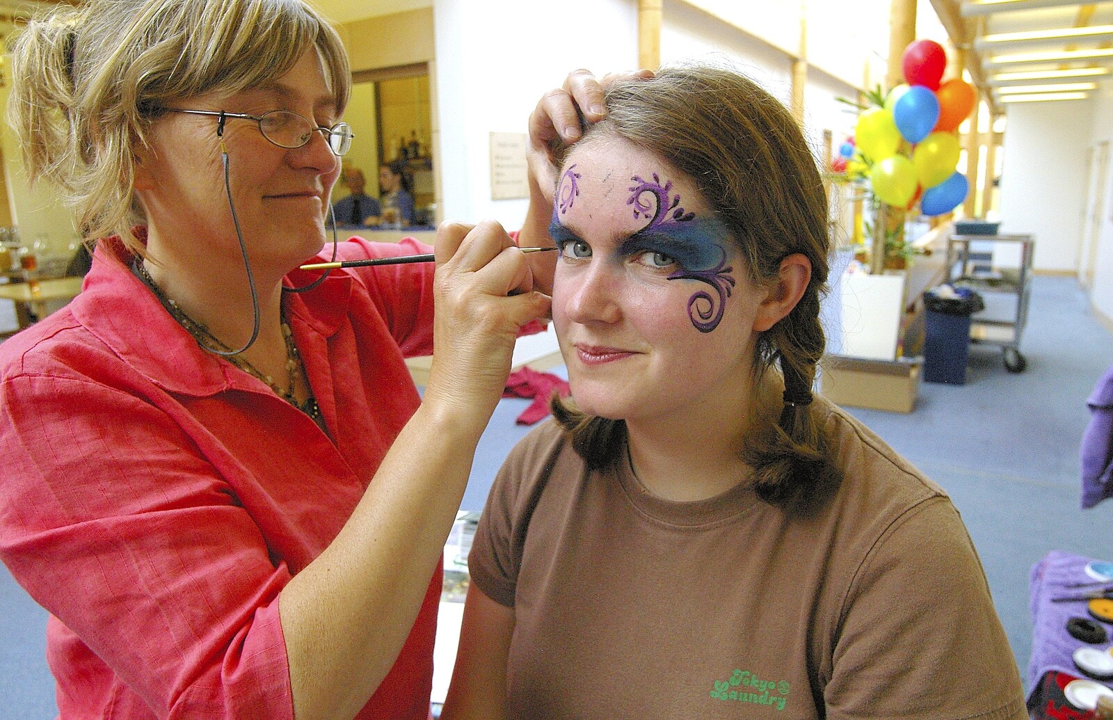 Isobel gets a bit of artwork applied from Qualcomm's Summer Circus Thrash, Churchill College, Cambridge - 18th August 2006
