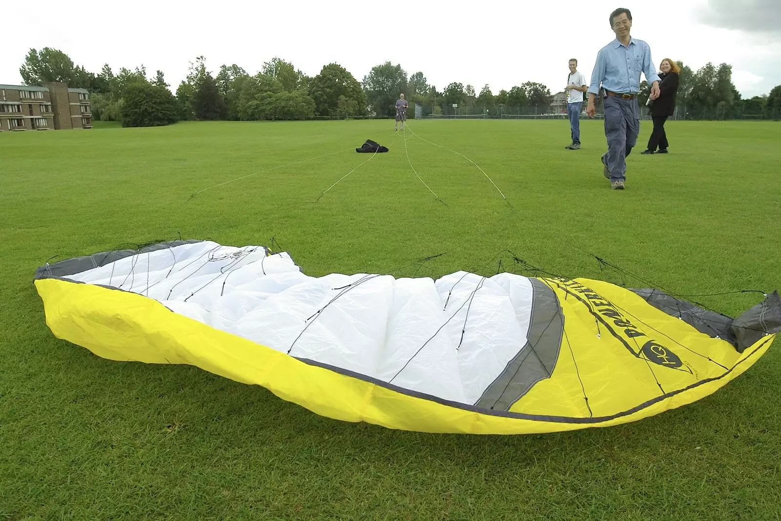 James retrieves Martin's crashed kite, from Qualcomm's Summer Circus Thrash, Churchill College, Cambridge - 18th August 2006