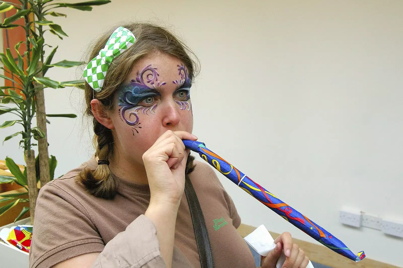 Isobel tests out a plastic bow and a party blower, from Qualcomm's Summer Circus Thrash, Churchill College, Cambridge - 18th August 2006