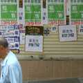 An old dude walks past posters, Wan Chai and Central, Hong Kong, China - 2nd October 2006