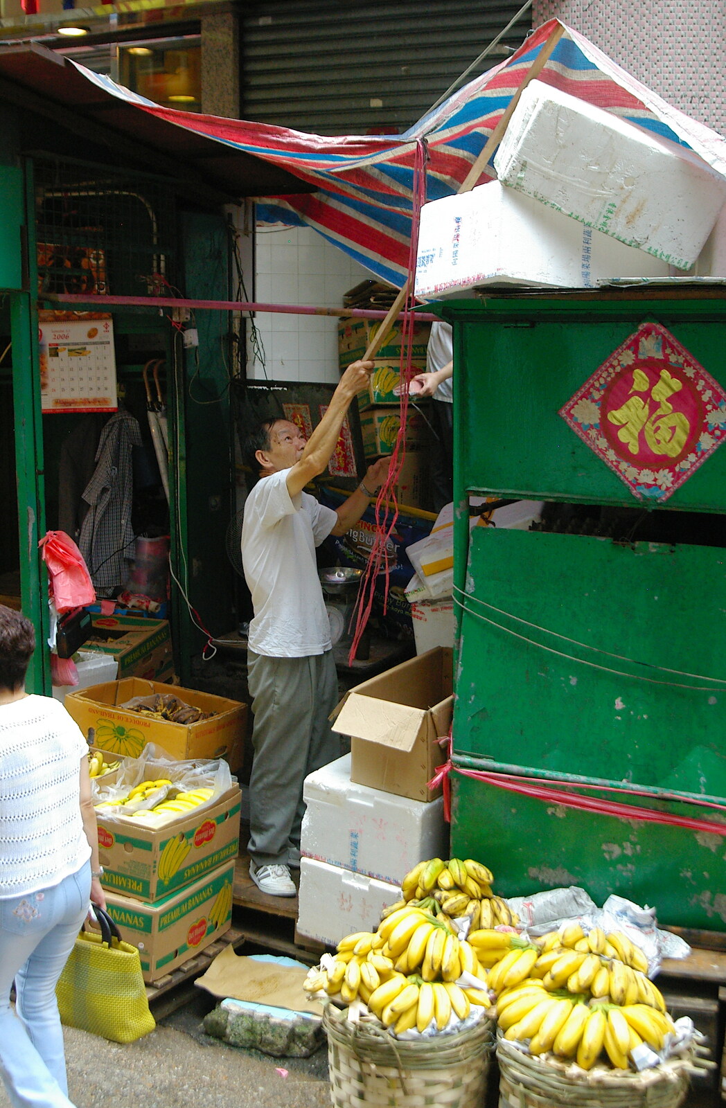 An ad-hoc awning is lifted into place from Lan Kwai Fong Market, Hong Kong, China - 4th October 2006