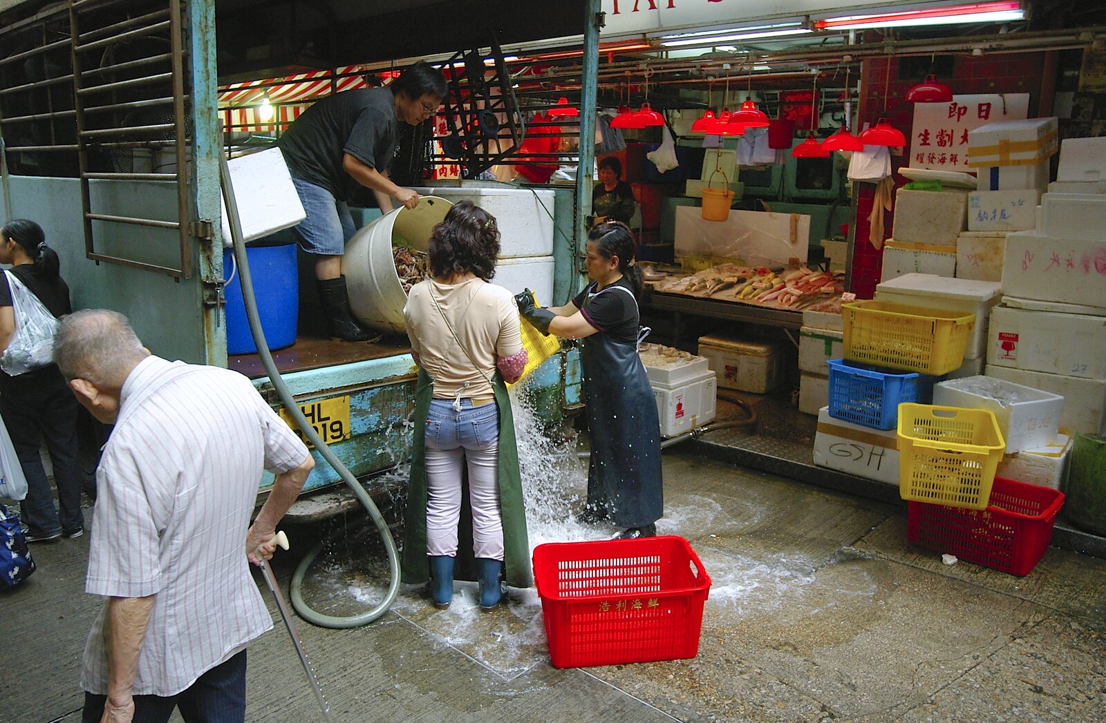 Ice water is tipped out onto the street from Lan Kwai Fong Market, Hong Kong, China - 4th October 2006