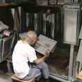 The tin dude reads the newspaper, Lan Kwai Fong Market, Hong Kong, China - 4th October 2006
