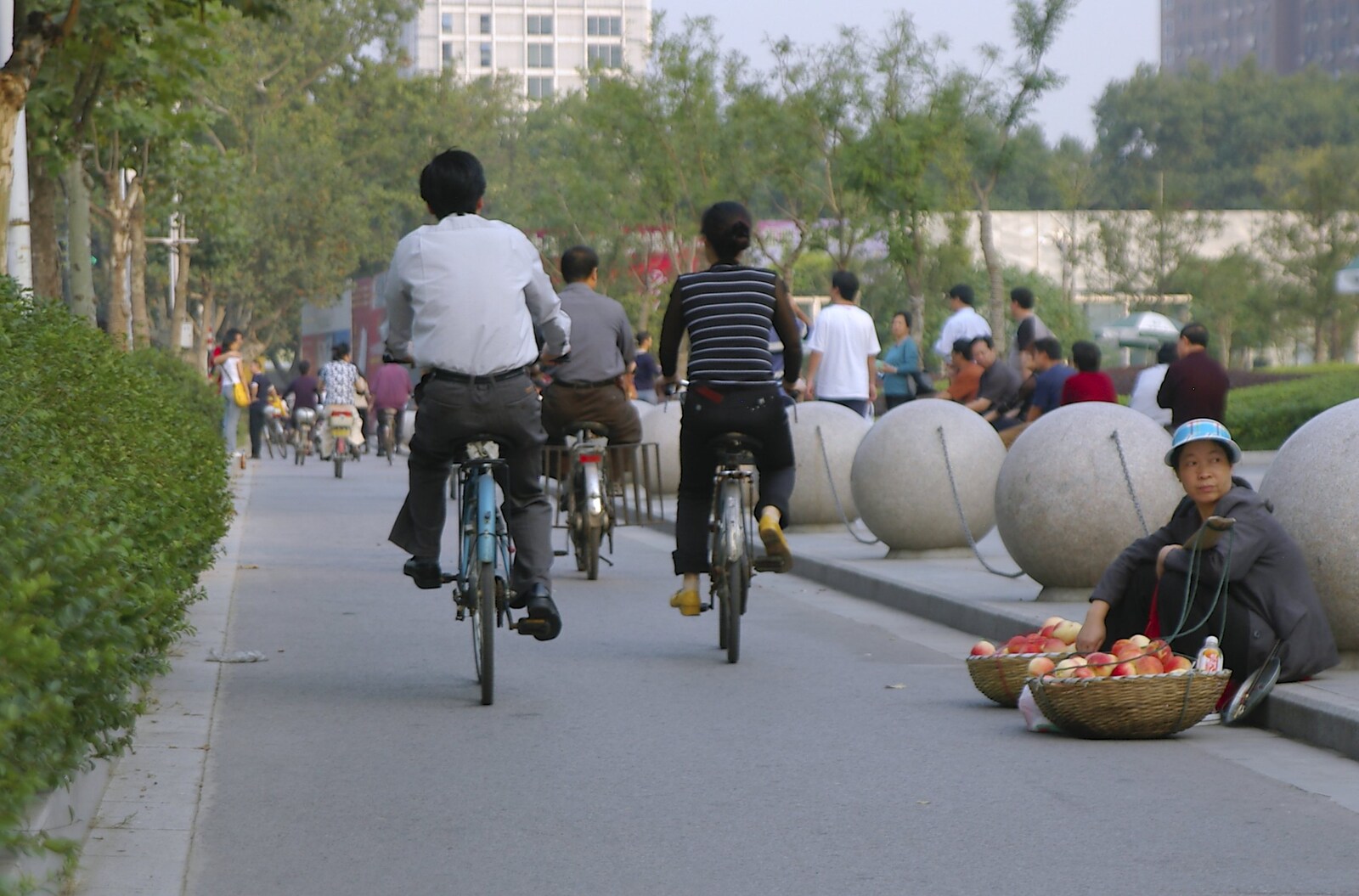A woman tries to sell fruit as cyclists pass by from A Few Days in Nanjing, Jiangsu Province, China - 7th October 2006