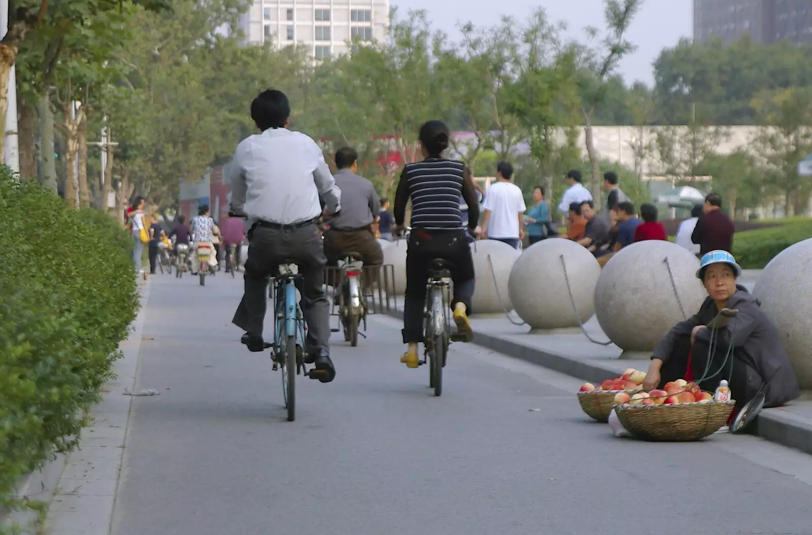 A woman tries to sell fruit as cyclists pass by, from A Few Days in Nanjing, Jiangsu Province, China - 7th October 2006