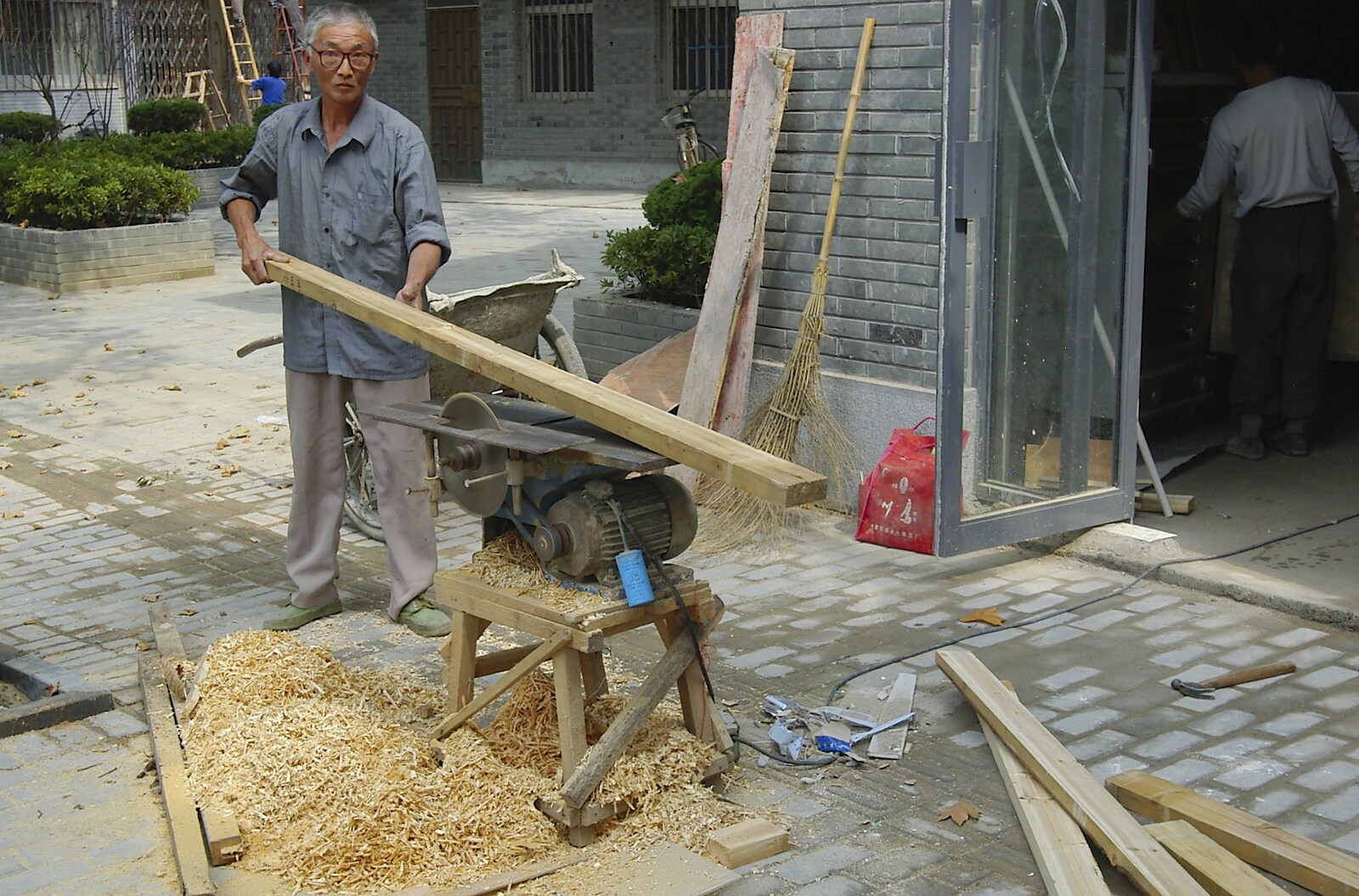 A guy saws wood in the street near the office from A Few Days in Nanjing, Jiangsu Province, China - 7th October 2006