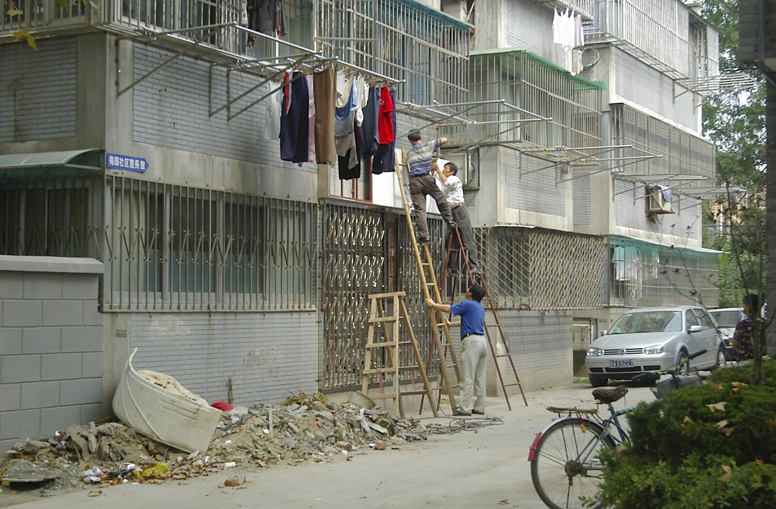 Dudes up a ladder talk animatedly about something from A Few Days in Nanjing, Jiangsu Province, China - 7th October 2006