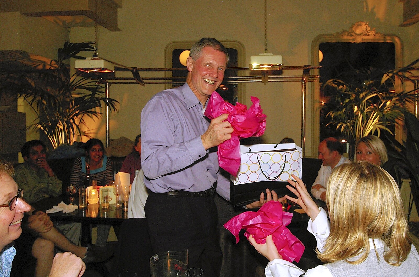 Tim unwraps a gift from Tim's 60th Birthday, Brown's Restaurant, Trumpington Road, Cambridge - 16th October 2006