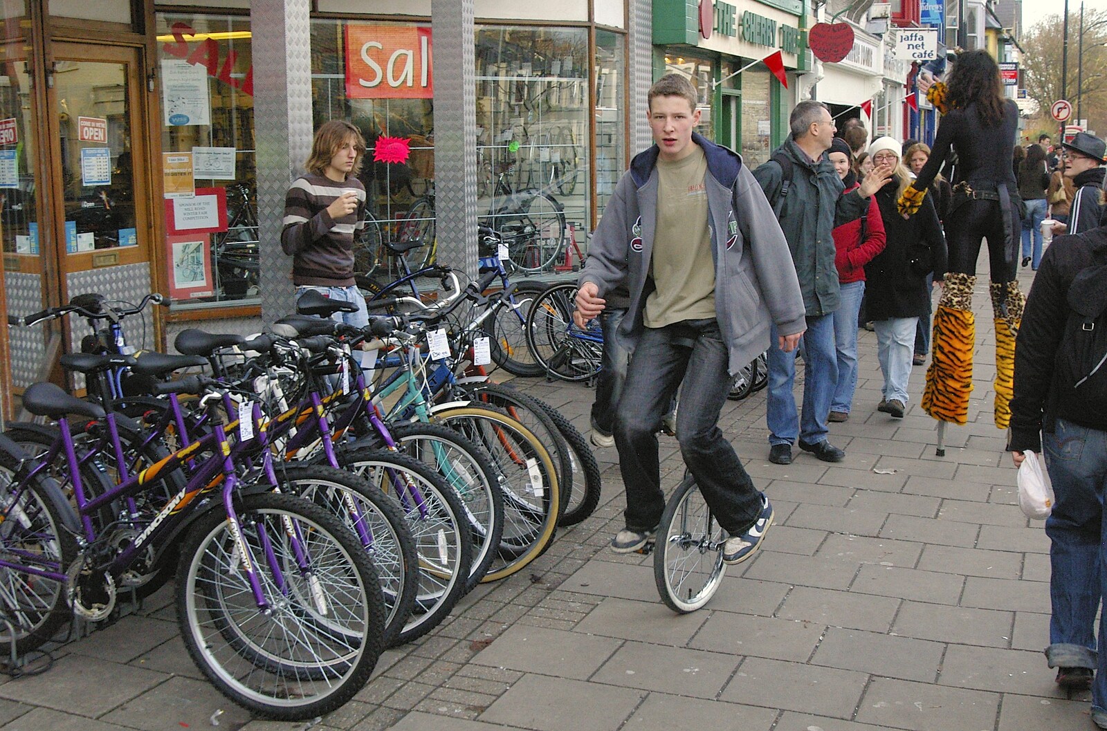 A guy unicycles past, er, a bi-cycle shop from The Winter Fair, Mill Road, Cambridge - 2nd December 2006