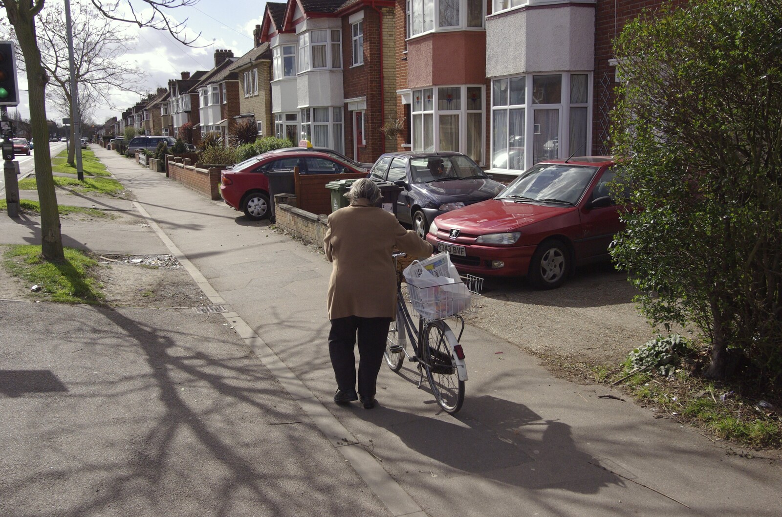 An old woman pushes a bike up Perne Road from The Derelict Salam Newsagents, Perne Road, Cambridge - 18th March 2007