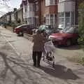 An old woman pushes a bike up Perne Road, The Derelict Salam Newsagents, Perne Road, Cambridge - 18th March 2007