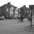 A couple of cyclists cross the road, The Derelict Salam Newsagents, Perne Road, Cambridge - 18th March 2007