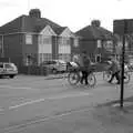 A couple of cyclists cross the road, The Derelict Salam Newsagents, Perne Road, Cambridge - 18th March 2007