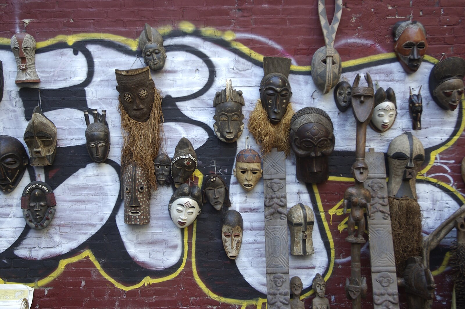 Crossing Brooklyn Bridge, New York, US - 26th March 2007: An interesting collection of masks on a wall