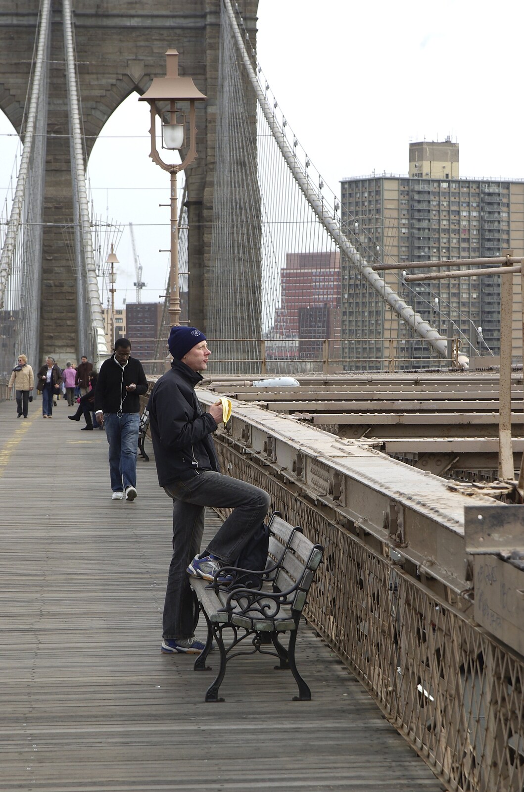 Crossing Brooklyn Bridge, New York, US - 26th March 2007: Some dude looks out over the city
