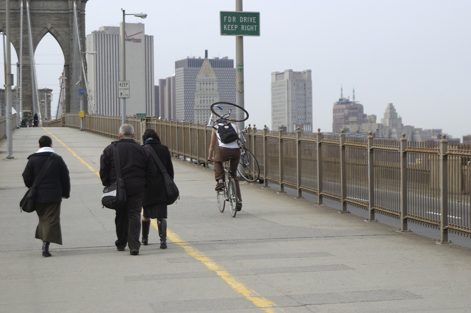 Crossing Brooklyn Bridge, New York, US - 26th March 2007: A cyclist carries a spare bike with him