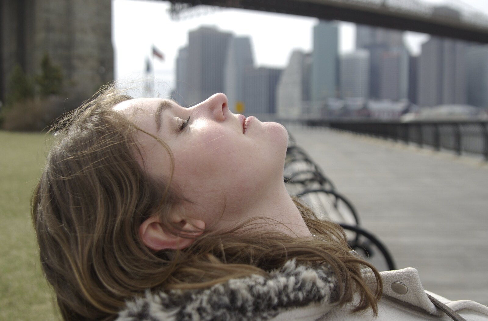 Crossing Brooklyn Bridge, New York, US - 26th March 2007: Isobel lies back on a bench
