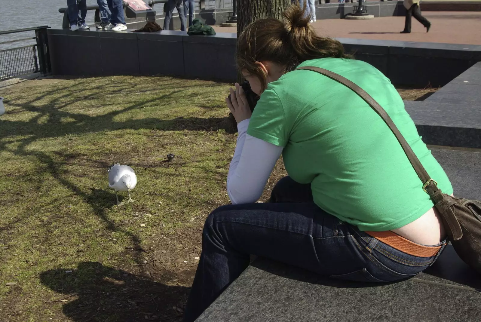 Isobel takes a photo of a gull, from Liberty Island, A Helicopter Trip and Madison Square Basketball, New York, US - 27th March 2007