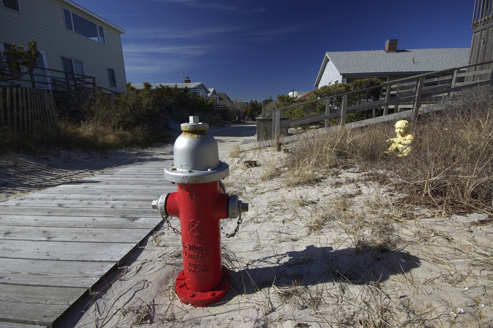 A Return to Fire Island, Long Island, New York State, US - 30th March 2007: A Fire Island fire hydrant is observed by a strange yellow statue