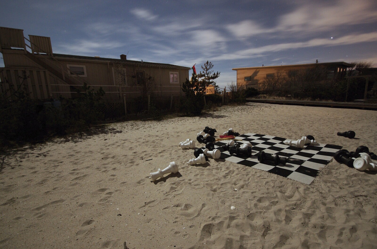 A Return to Fire Island, Long Island, New York State, US - 30th March 2007: The giant chess set's pieces lie discarded in the moonlight