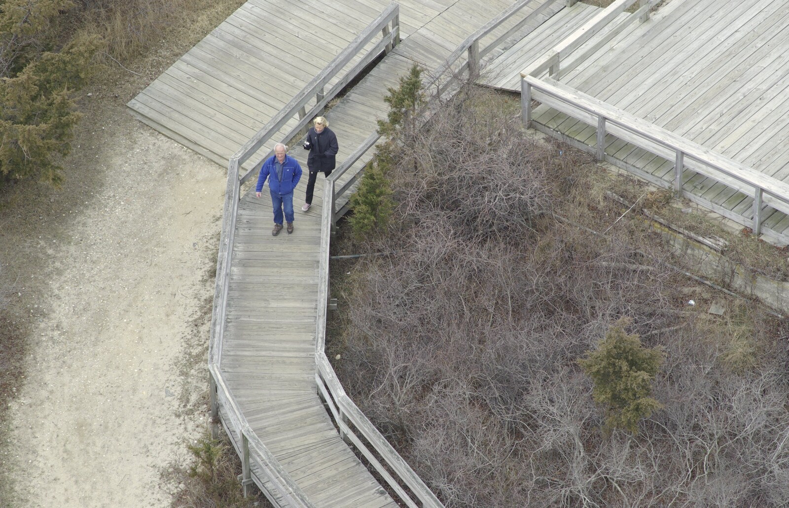 A Return to Fire Island, Long Island, New York State, US - 30th March 2007: A couple walk along the boardwalk up to the lighthouse