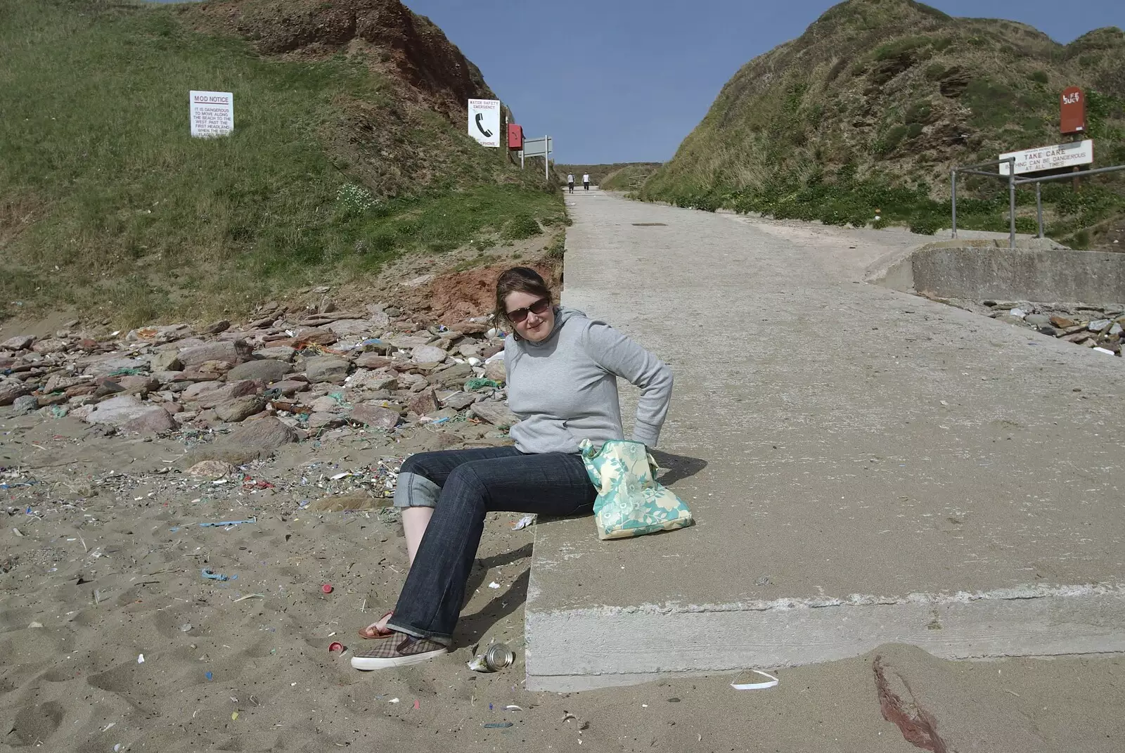 Isobel stops to change feet on Whitsand Bay beach, from A Trip to The Barbican, Plymouth, Devon - 6th April 2007