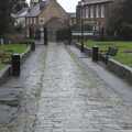 The rainy cobbled path leads from the priory to the town