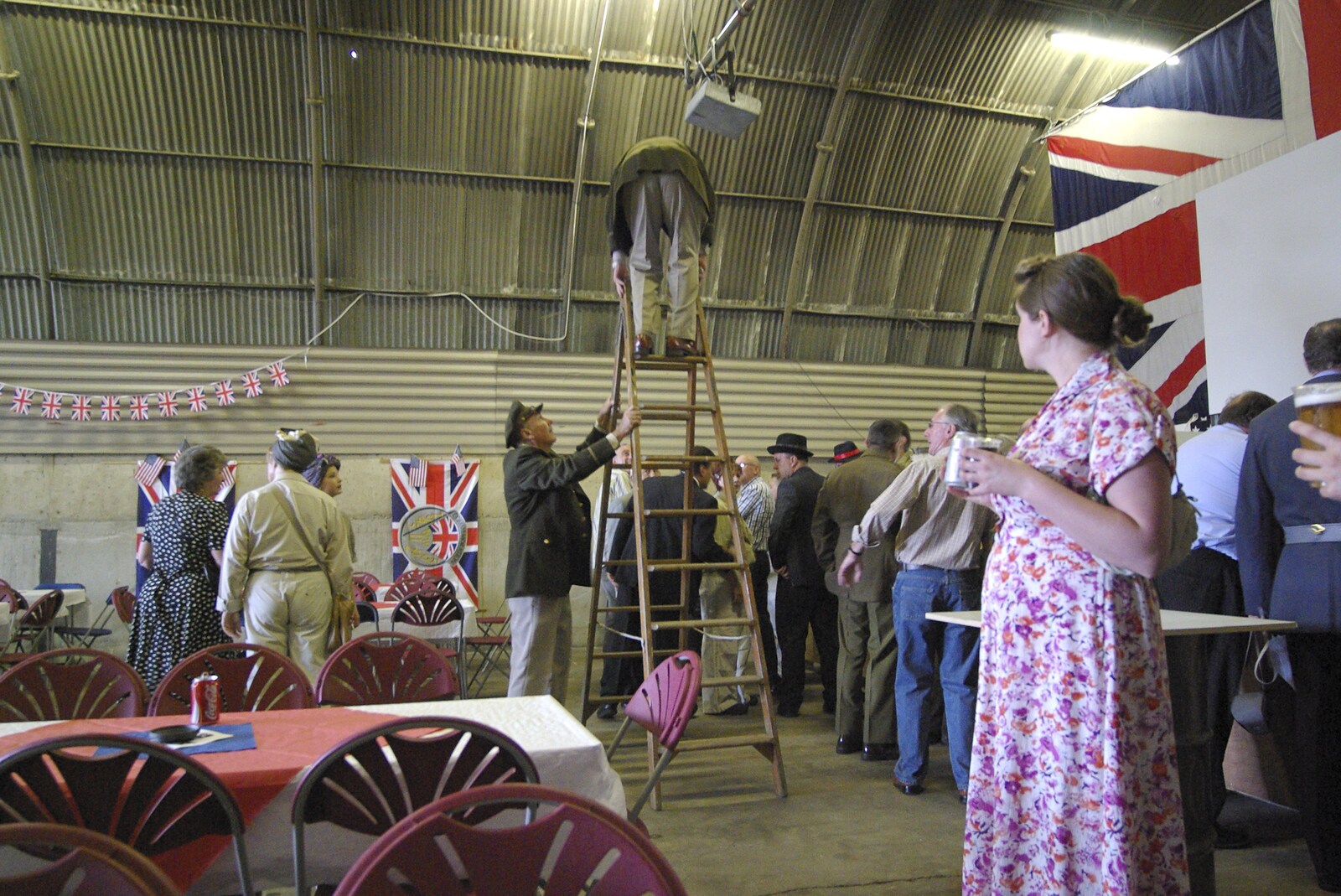 A 1940s Airfield Hangar Dance, Debach, Suffolk - 9th June 2007: Richard holds the ladder as the projector is fixed