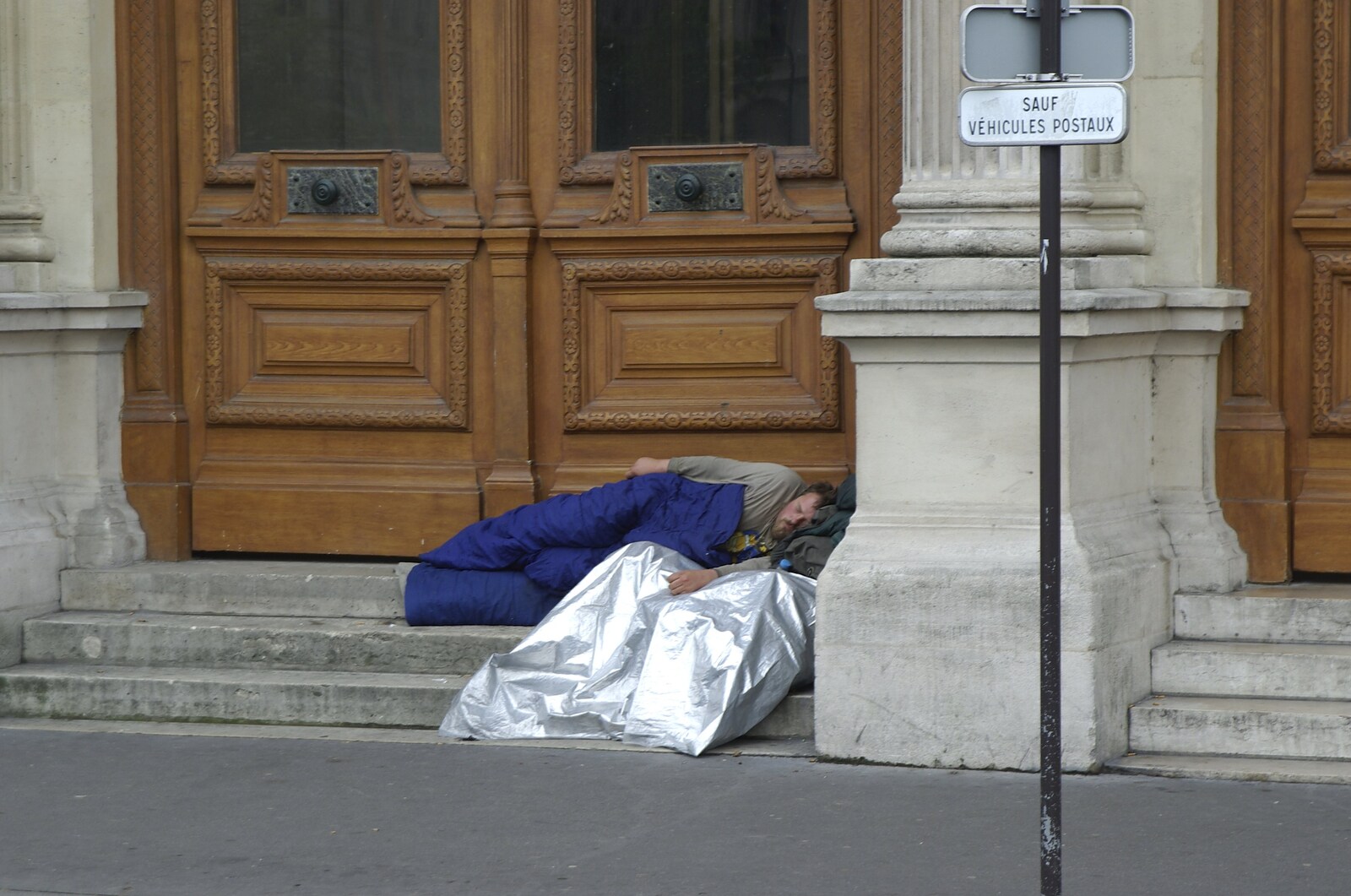 Genesis Live at Parc Des Princes, Paris, France - 30th June 2007: A homeless dude sleeps under 'Liberté, Egalité, Fraternité'