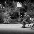2007 A sad street-dude sits alone and looks at a passing pigeon.