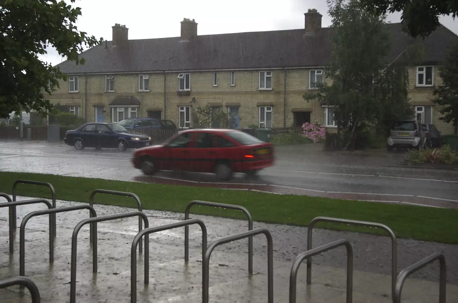 It's lashing it down on Brooks Road, from Genesis Live at Twickenham, and Music on Parker's Piece, London and Cambridge - 8th July 2007