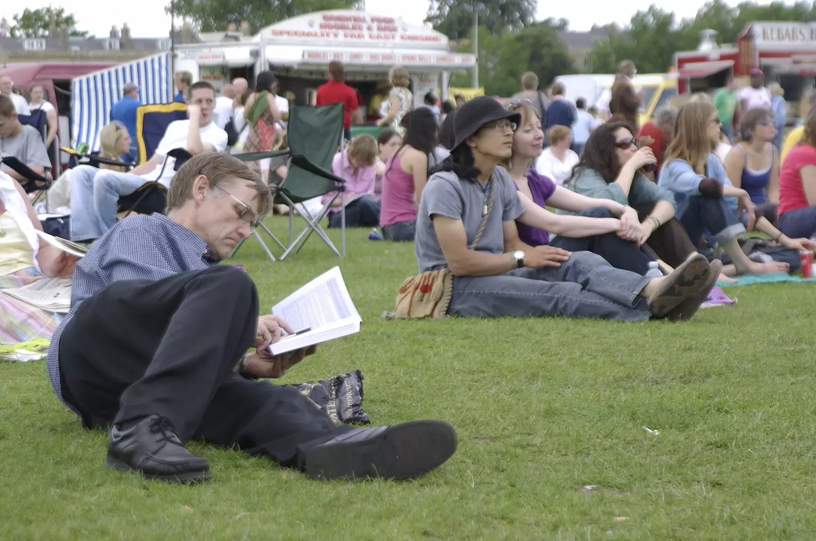 Some dude reads a book, from Genesis Live at Twickenham, and Music on Parker's Piece, London and Cambridge - 8th July 2007