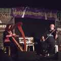 A harpist and fiddler from Scotland, in the Club Tent
