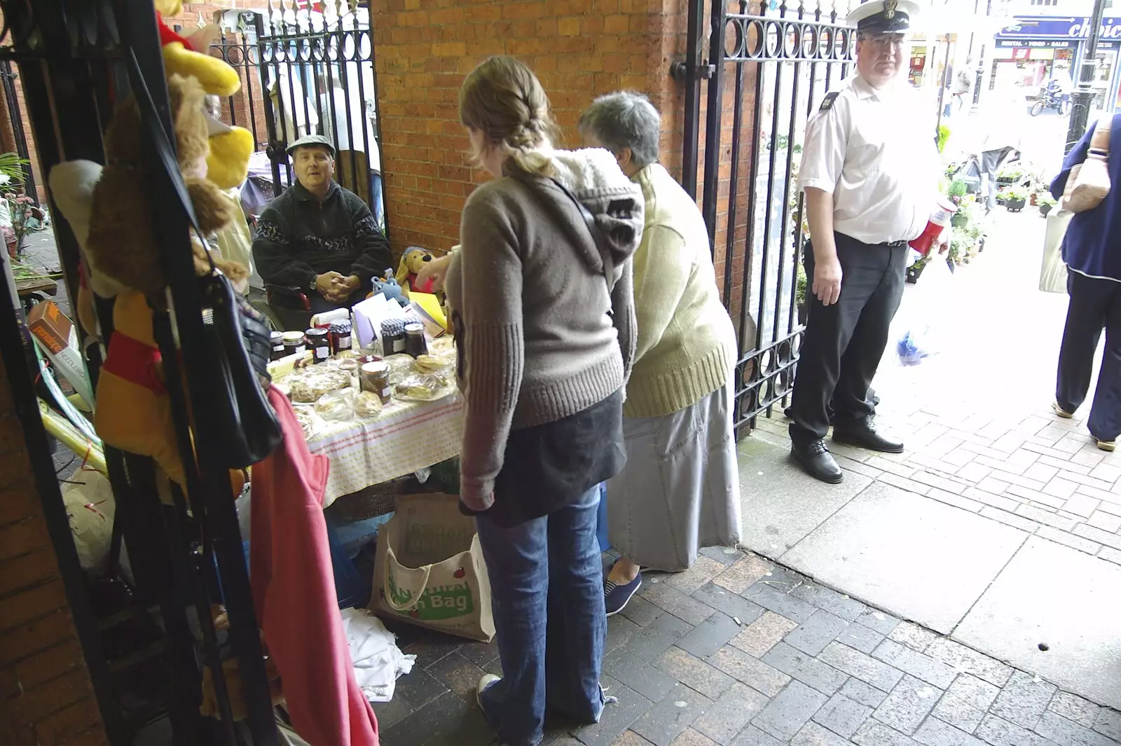 Isobel scopes out a WI stall in Sandbach Market, from A Road Trip to Ireland Via Sandbach and Conwy, Cheshire and Wales - 21st September 2007