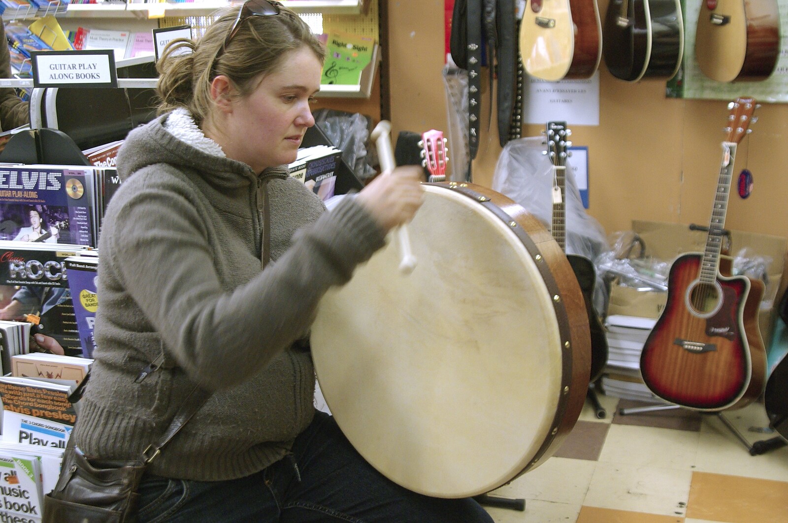 Kilkee to Galway, Connacht, Ireland - 23rd September 2007: In a music shop, Isobel tries out a bit of bodhrán