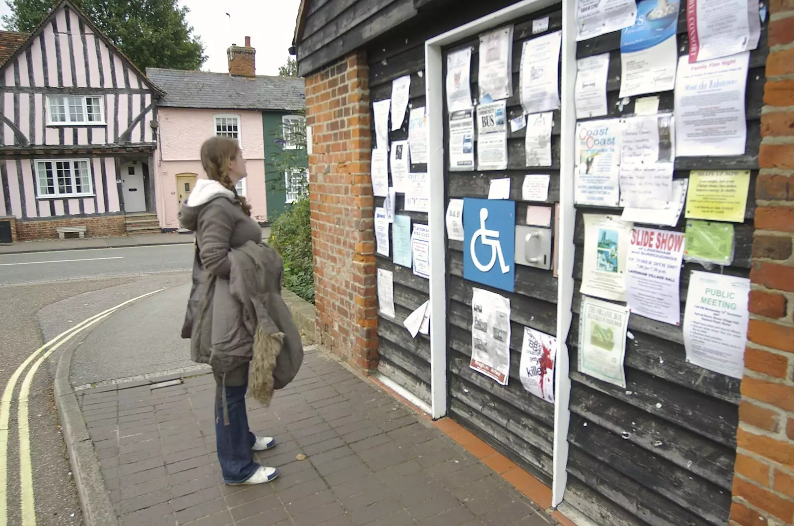 Isobel looks at the town noticeboard, from A Road Trip in an MX-5, and Athlete at the UEA, Lavenham and Norwich - 14th October 2007